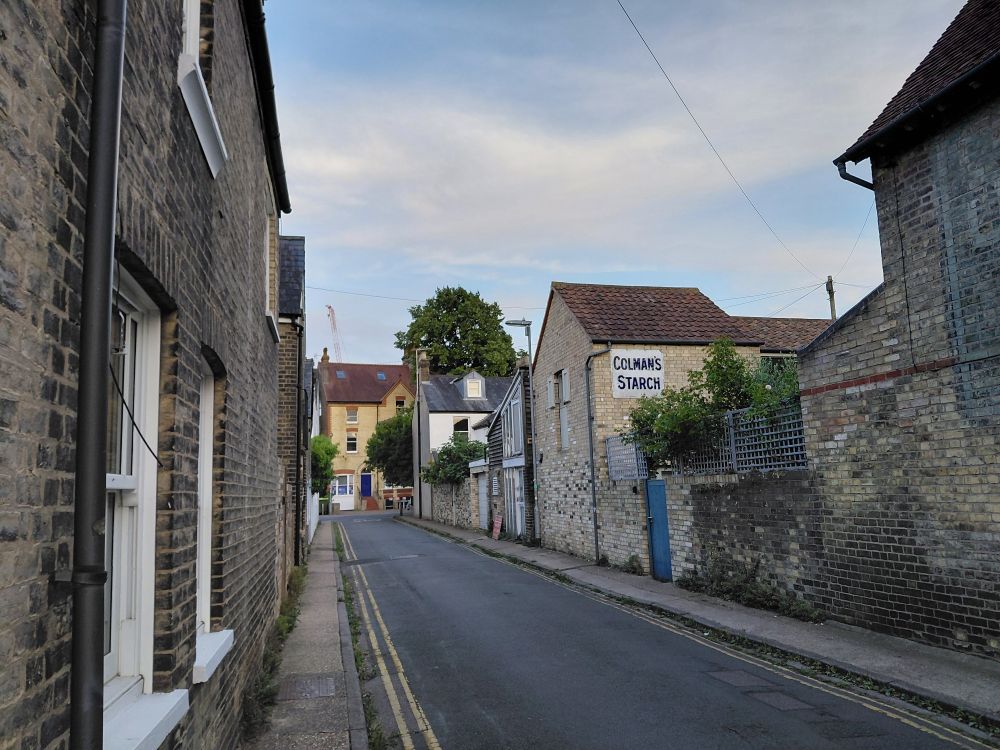 A back street in Cambridge, one building bears an old painted advert for Colman's Starch