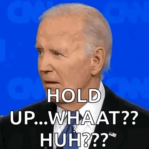 a man in a suit and tie says " hold up what huh "