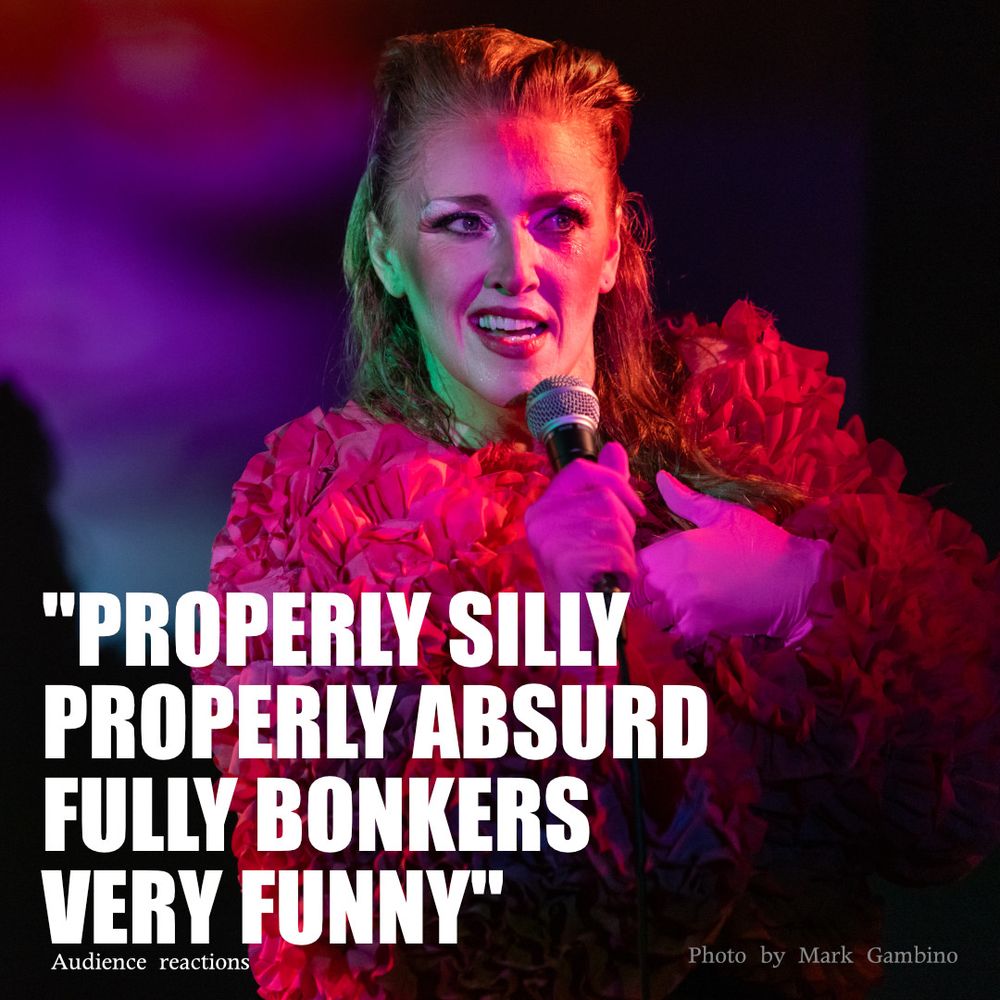 Redheaded sweaty woman in a ruffled pink top with a microphone with the quote "Properly silly, properly absurd, fully bonkers, very funny"