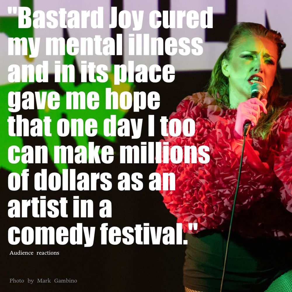 Sweaty redheaded woman in high fashion pink ruffled top at a microphone with text superimposed “Bastard Joy cured my mental illness and in its place gave me hope that one day I too can make millions of dollars as an artist in a comedy festival”