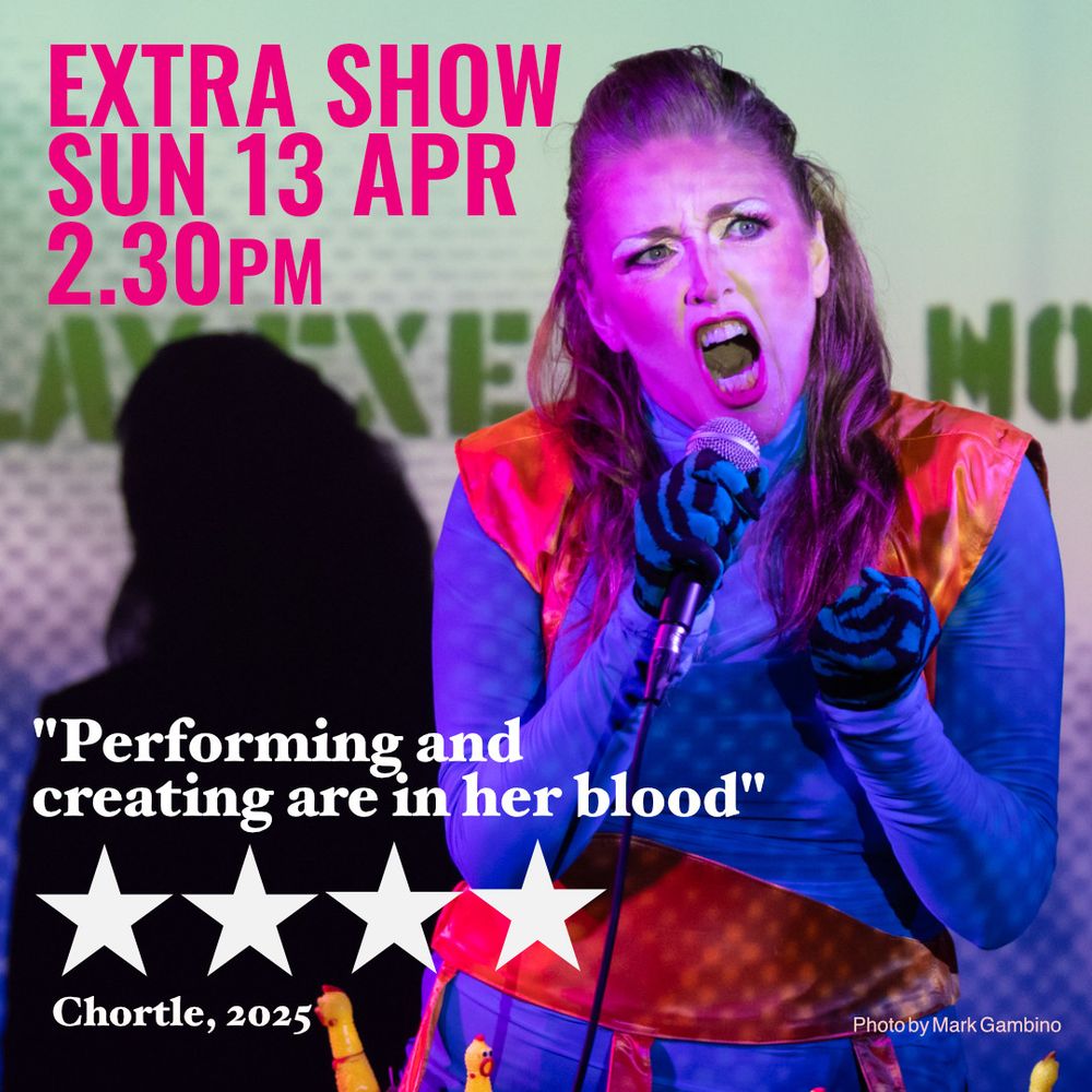 Redheaded 49 year old woman singing lustily, dressed in a blue long-sleeved wiggle dress and orange bolero festooned with rubber chickens. Text (4 stars) "Performing and creating are in her blood"  