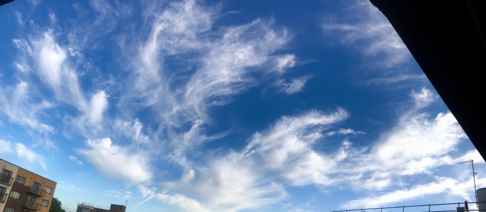 Blue sky with fluffy clouds that look like they’ve been combed 