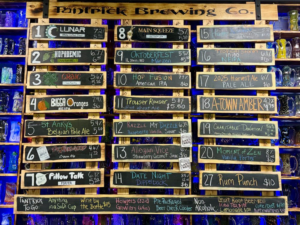 A list of 21 different beers and names on wooden signs at Tantric Brewing Company. 