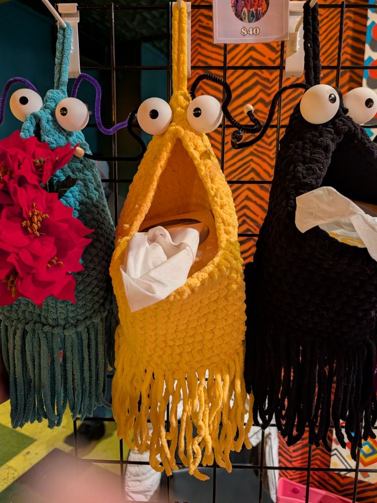 3 crocheted bags with fringe in teal, yellow, and black that resemble Sesame Street Yip Yip Martians