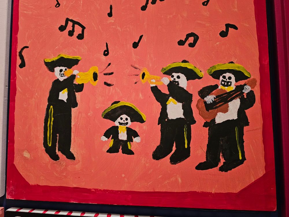 A painting of 4 skeletons dressed in mariachi outfits and playing music. One of them is very short.