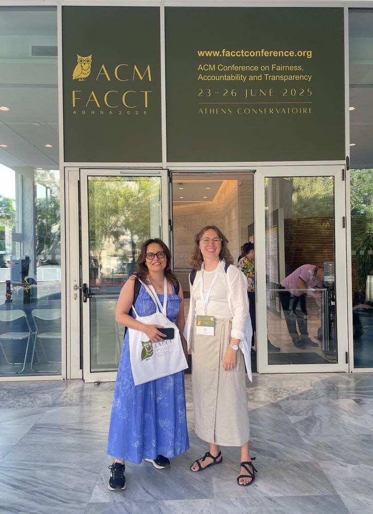 Tania Duarte and Lizzie Remfrey in front of the Consertoire conference venue with FACTT sign