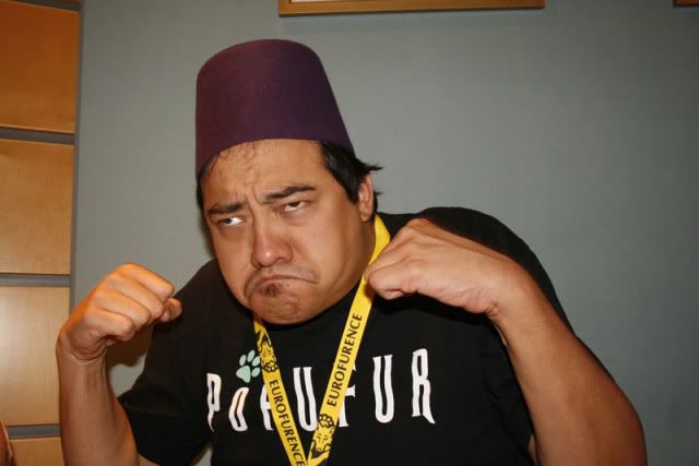 Me making a face! From EuroFurence 15 in 2009, Suhl Germany. Wearing a fez and “POPUFUR” shirt