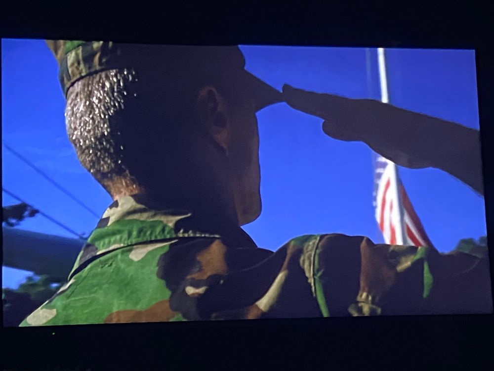 Gunnery Seargent Tom Highway salutes the Stars  'n Stripes