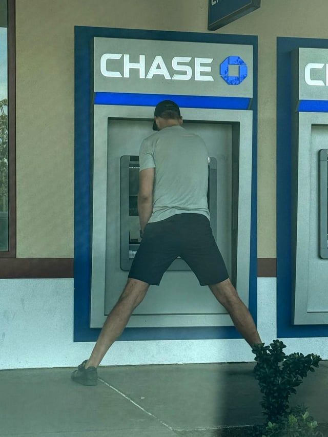 Tall man with wide stance using ATM 