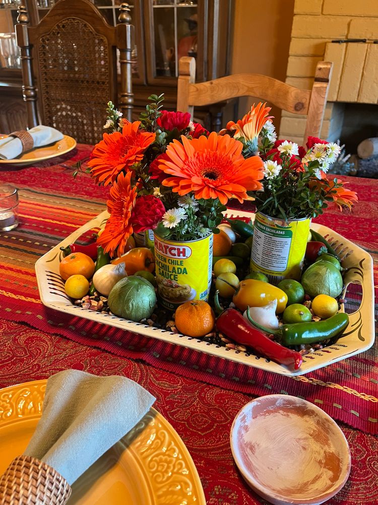 Table centerpiece of flowers, fruit and vegetables 