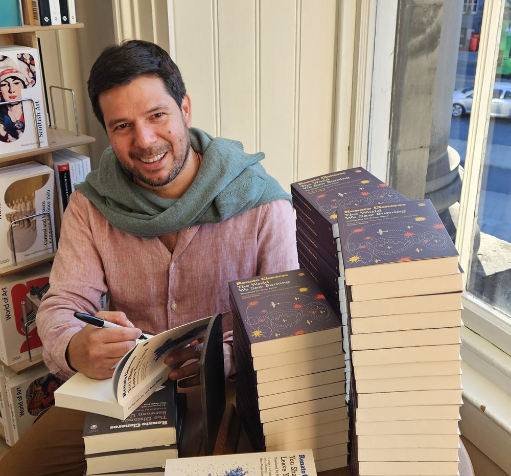 Renato signing books