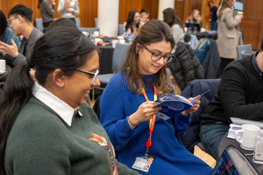 Two people, one looking at course brochure