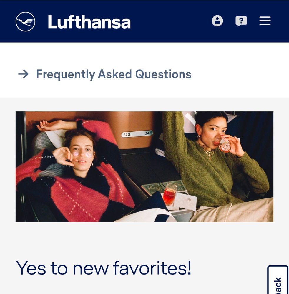 Screenshot of photo on Lufthansa website. Two women posing in business class seats as if it was high fashion shoot. 