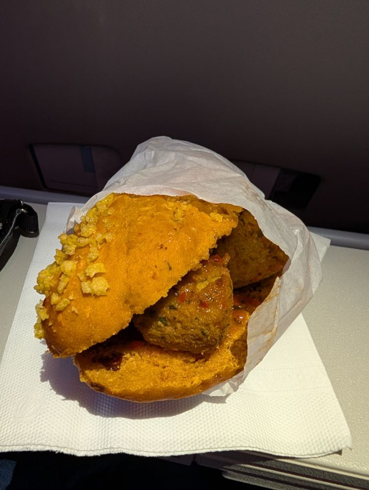 Sandwich with falafel on a plane tray table