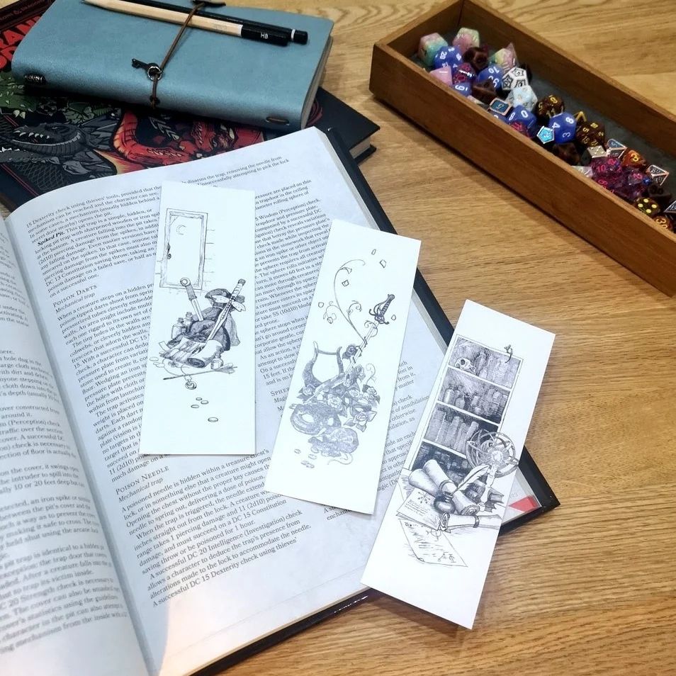 Photo of three dnd themed black and white illustrated bookmarks