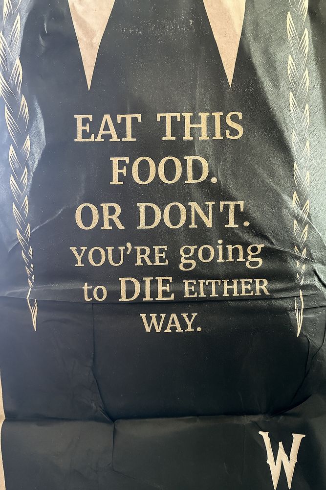 Wendy's fast food bag with "EAT THIS FOOD. OR DONT. YOU'RE going to DIE EITHER WAY."