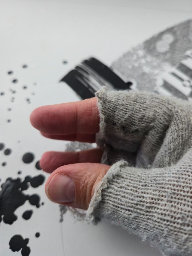 Leith's fingers and hand in a grey woven glove.  The finger covers have been roughly cut in half to allow finger tip feeling.