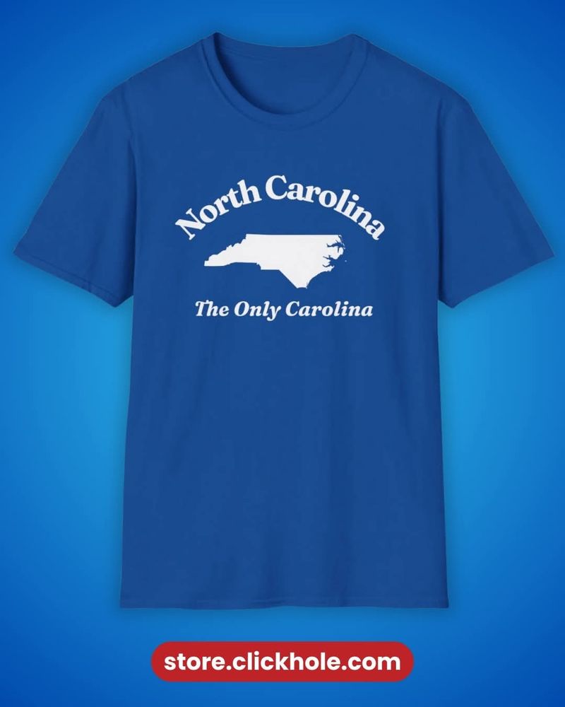 A blue t-shirt with an outline of North Carolina in white and the words " North Carolina The Only Carolina"