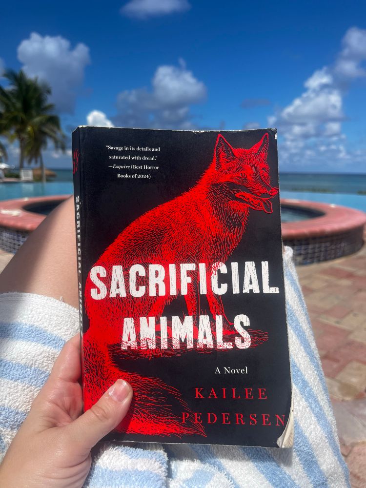 Sara your beautiful friend is poolside by the ocean of Grand Cayman with SACRIFICIAL ANIMALS by Kailee Pedersen
