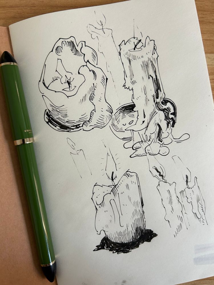 candle illustrations inside of a sketchbook done in black ink. a green fountain pen sits in the sketchbook gutter