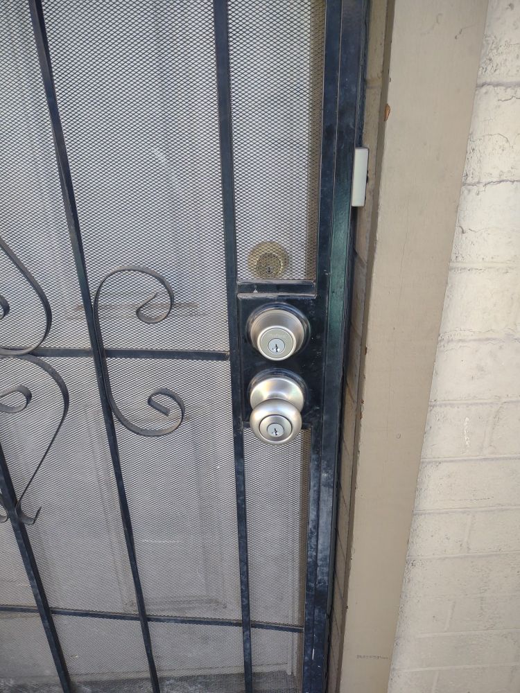 Security door with nickel deadbolt and knob