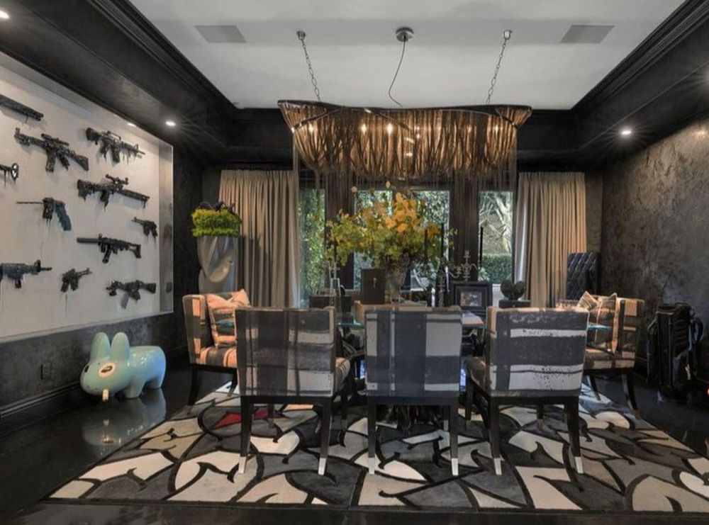 Hideously gaudy dining room with wall decor made of weapons of war.  