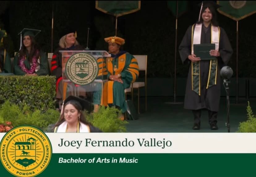 Joey Fernando Vallejo walking across the stage receiving his Bachelor of Arts in Music