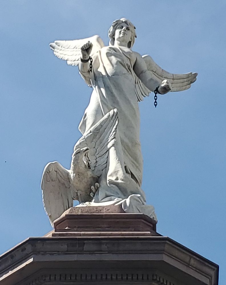 Statue of an angel breaking the chains of bondage with an eagle at her feet. Zacatecas Centro, Mexico at Jardin de Independencia.