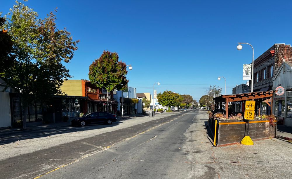 Southbound Solano Ave, one car can be seen in the distance, virtually all the parking spaces are empty. 