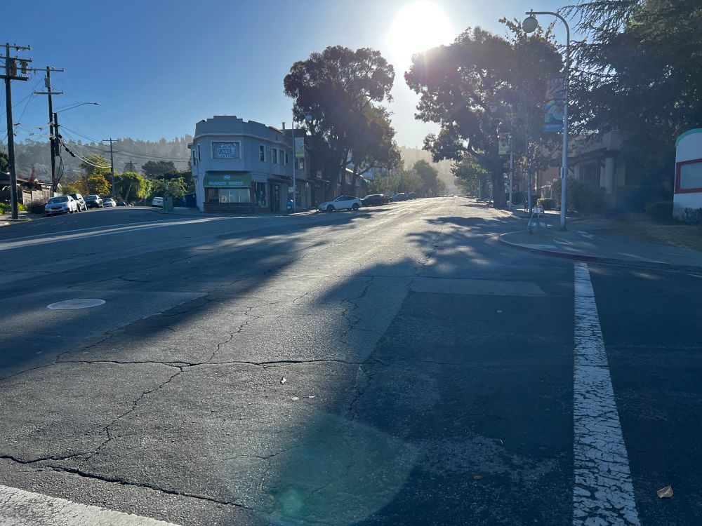 Northbound Solano Ave, no vehicle traffic is seen, vast majority of parking spaces are not being used. 