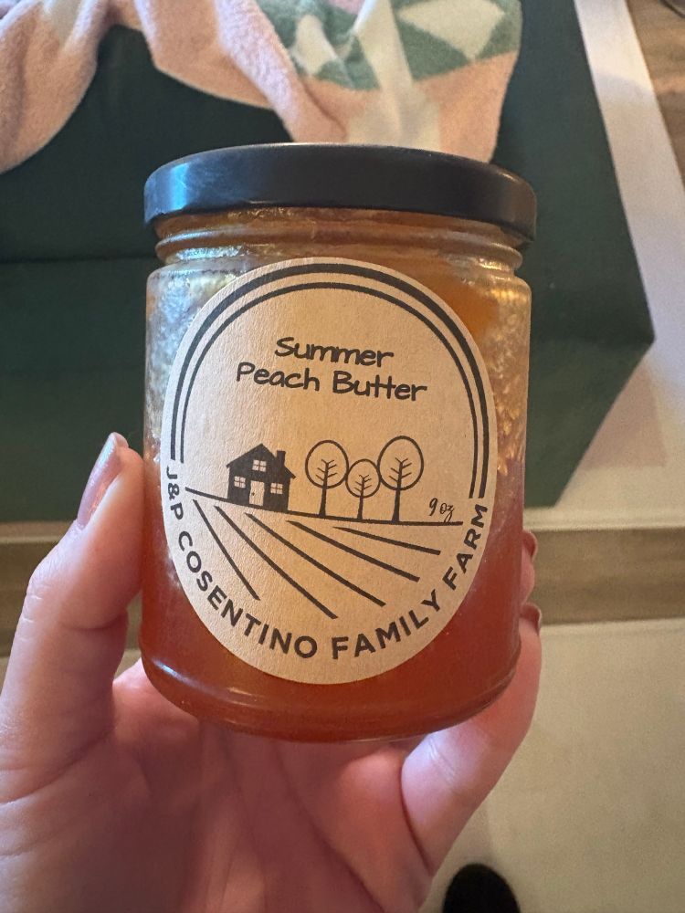A half filled jar of summer peach butter from J&P Cosentino Family Farm