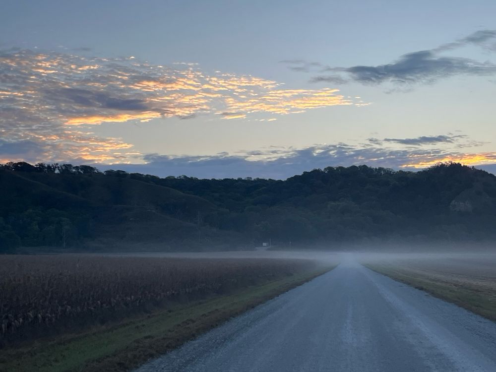 Mist rises from the road at sunrise along the Iowa bluffs that line the Missouri River basin