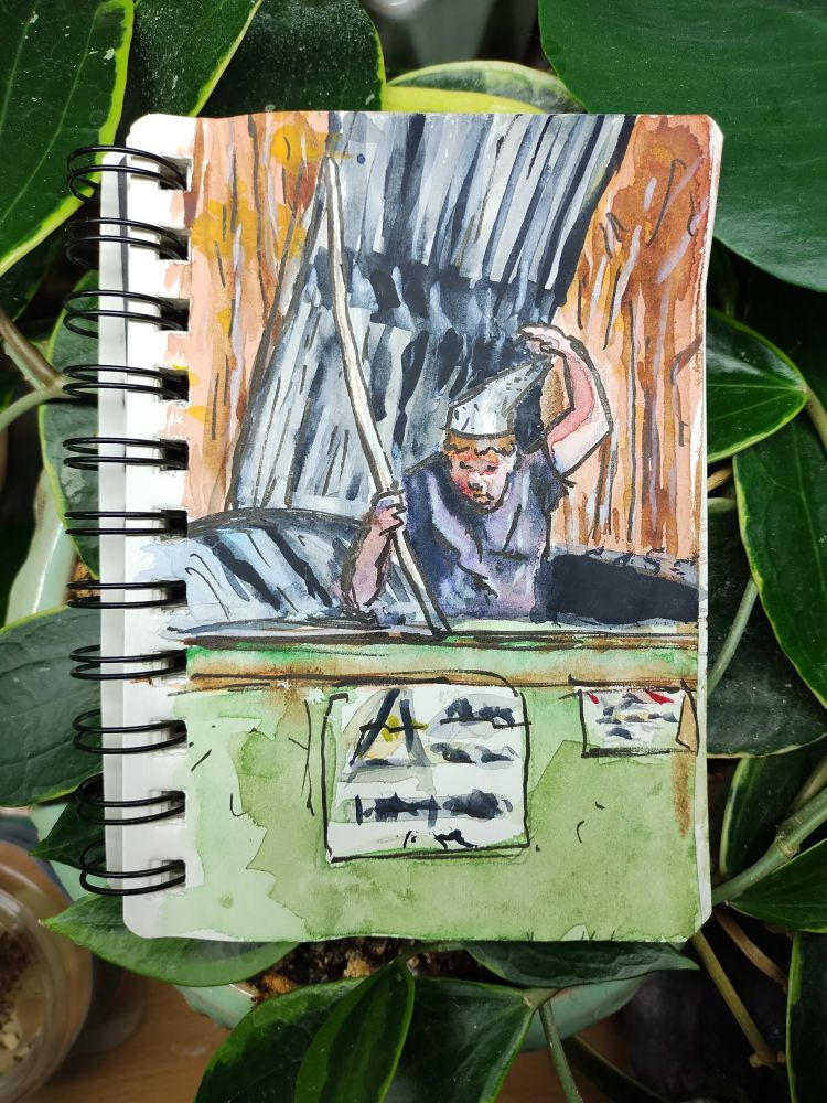 Man wearing a foil hat popping out of a dumpster holding a stick