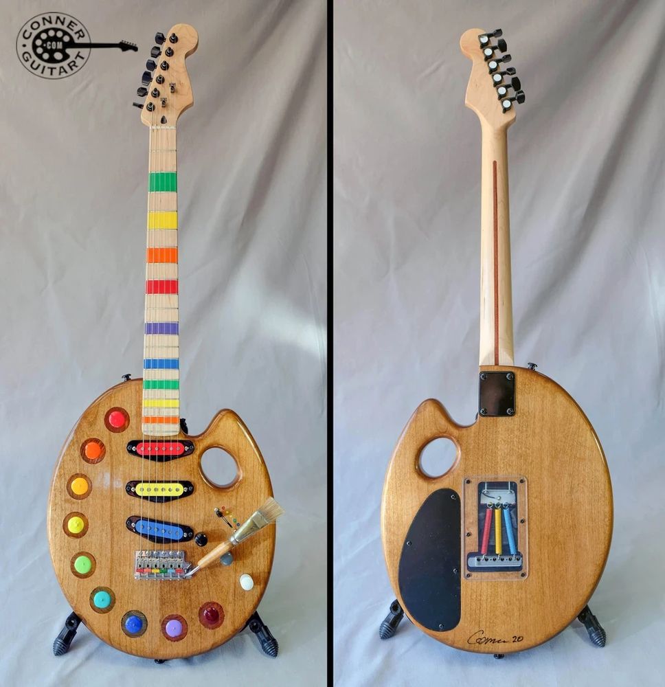 A custom guitar that is shaped like an artist's palette