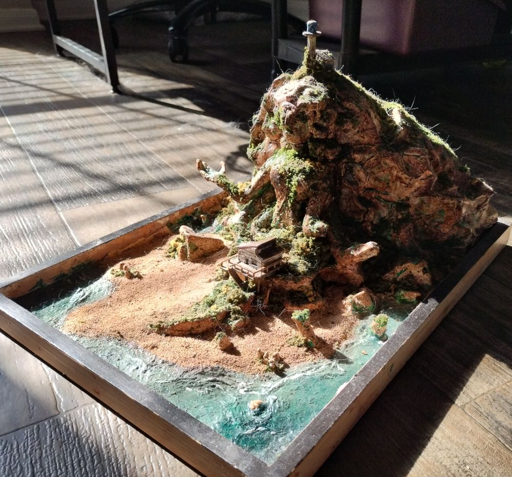 A sculpture of Steven Universe's home on the side of a mountain, facing the sea