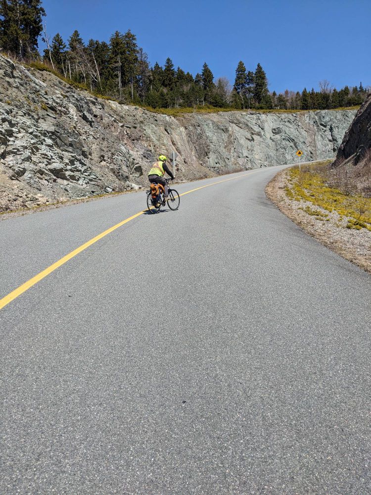 A cyclist doing switchbacks up a hill that has a 16% grade