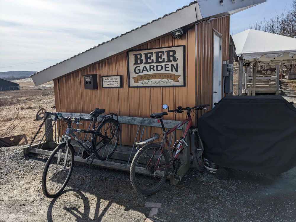 A sign saying Beer Garden Horton Ridge with a bike rack and two bikes in front of it. 