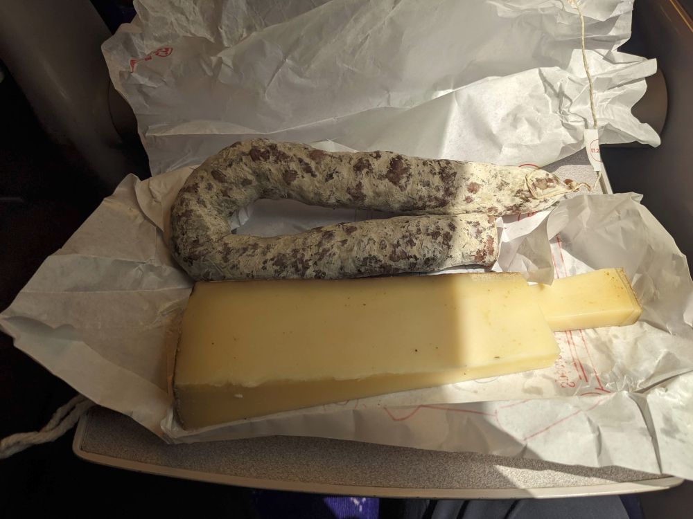 Saucisson and cheese wrapped in paper. 