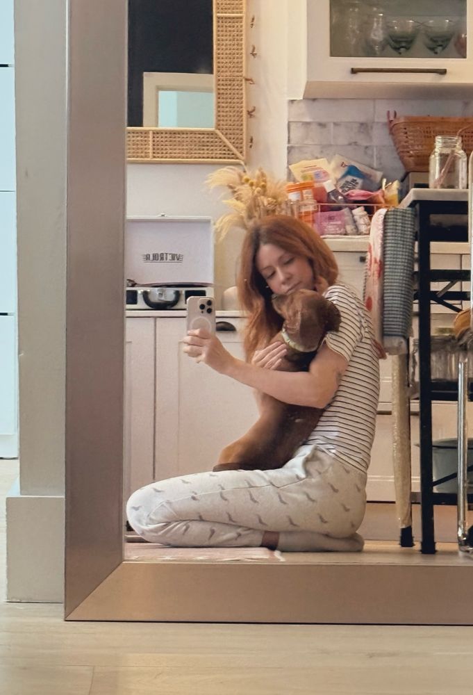 A selfie of woman holding a dachshund 