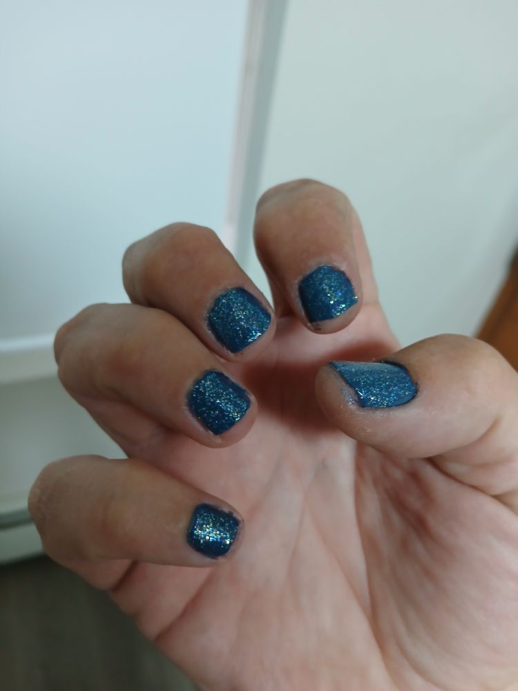 My right hand with sparkly blue nails.
