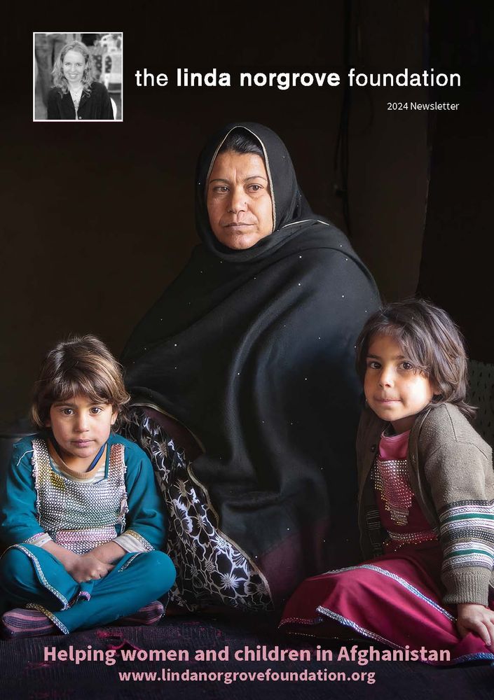 Cover of newsletter showing Afghan woman sitting with two small children.