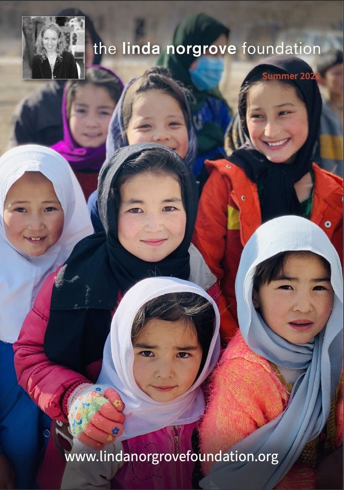 Cover of newsletter showing seven Afghan girls smiling.