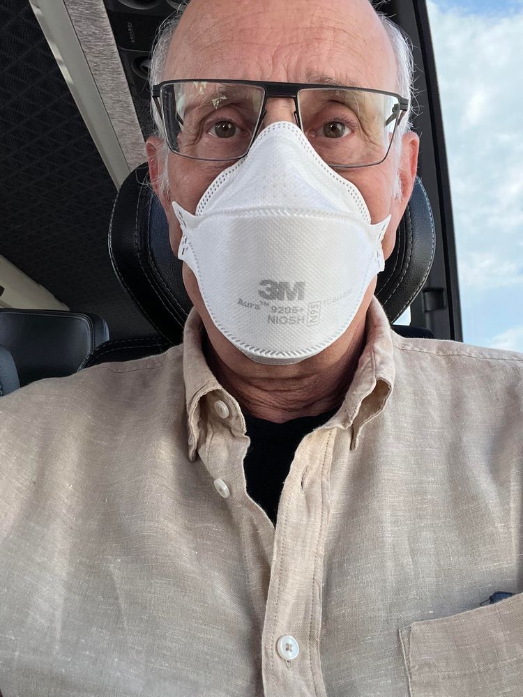 masked selfie in a linen button down shirt 