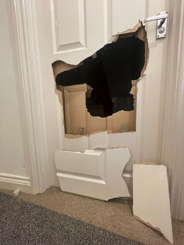 My bathroom door with a big hole in it