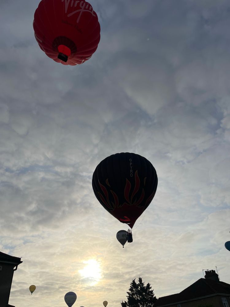 Several hot air balloons at sunrise 