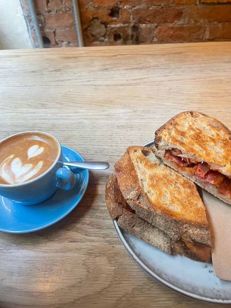 A flat white and a sourdough bacon toastie