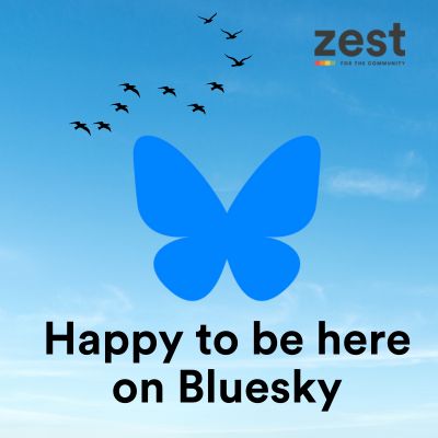 Happy to be here on Bluesky. Wth a picture of brids flying and Bluesky logo. 