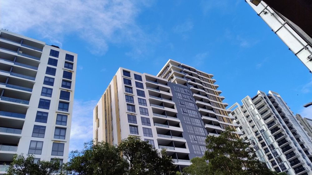 Blue Sky above tall apartment buildings