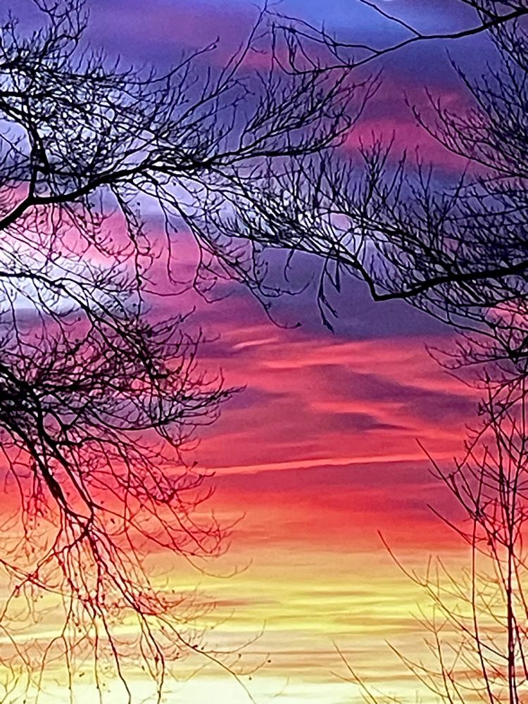 Beautiful colors of red, orange, purple, yellow and pink in many shades at sunset in Minnesota.