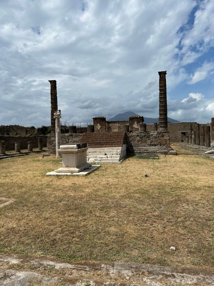 Temple of Jupiter, Pompeii. Vesuvius looms in the background.